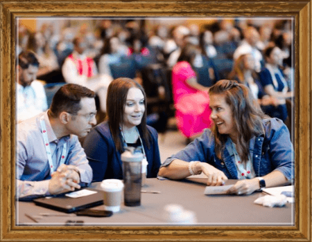People talking at a table, smiling, relalxed